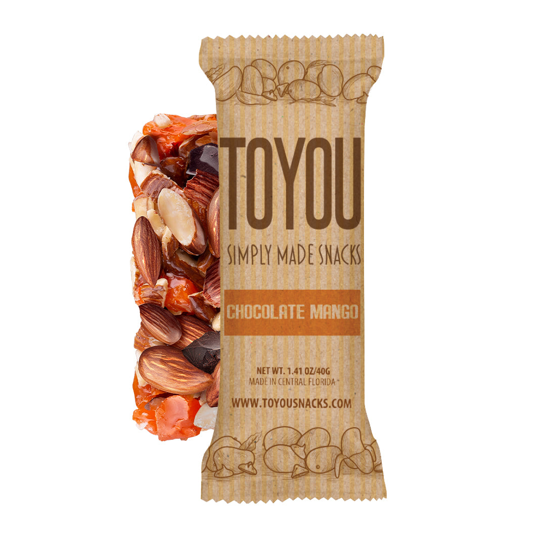 Front view: Chocolate Mango ToYou Snack bar in artistic paper wrapper next to unwrapped snack bar (almonds, chocolate, yogurt chips) on a white background.
