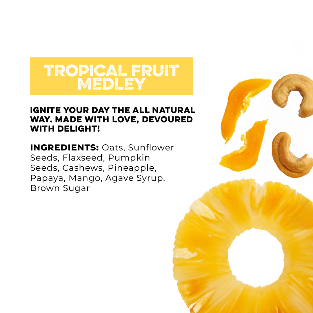Top view (Bottom right): Pineapple slice next two dried mango pieces and two cashews. (Top left): “Tropical Fruit Medley” above the text “Ignite your day the all natural way. Made with love, devoured with delight!” and the granola’s ingredient below it. 