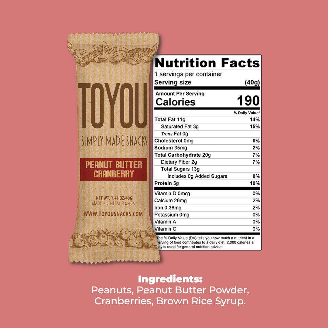 Front view: Peanut Butter Cranberry ToYou Snack bar in artistic paper wrapper next to the snack bar’s nutrition facts, above the Snack bar’s ingredients on a light red background.